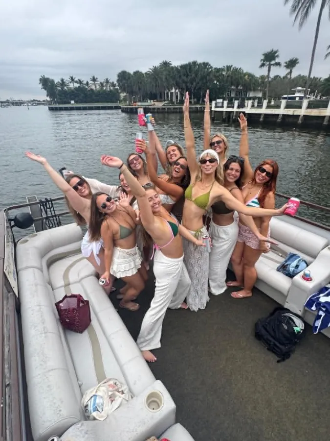 Bachelorette party cheering aboard the Breezy Tiki pontoon in Fort Lauderdale